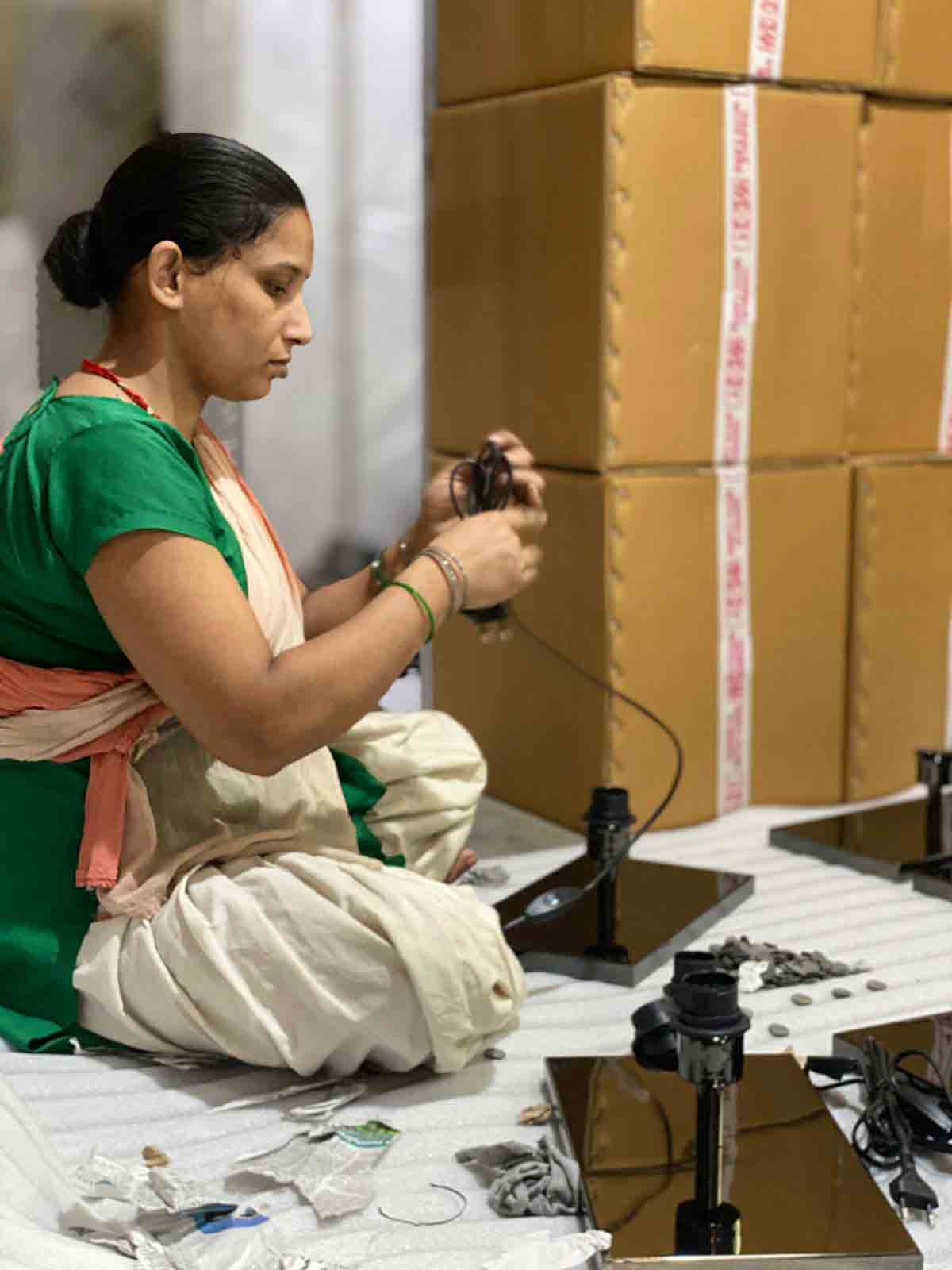 a woman working on decorative light
